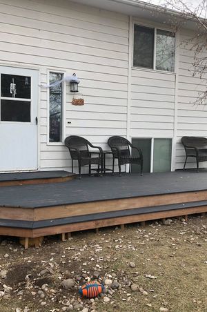 A front porch made with composite decking with wrap around single stair. 