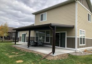 Back porch cover with a metal roof and new porch patio out of cement. 